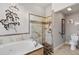 This bathroom features a modern tiled shower and a luxurious soaking tub at 26111 Feathersound Dr, Punta Gorda, FL 33955