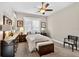 Spacious bedroom with a ceiling fan, carpeted floor, and large windows at 26111 Feathersound Dr, Punta Gorda, FL 33955