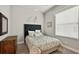 Cozy bedroom with neutral decor, carpet flooring, and natural light from the window at 26111 Feathersound Dr, Punta Gorda, FL 33955