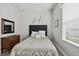 Cozy bedroom with neutral decor, carpet flooring, and natural light from the window at 26111 Feathersound Dr, Punta Gorda, FL 33955