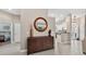 Inviting entryway featuring tile floors, a decorative mirror, and a unique console table at 26111 Feathersound Dr, Punta Gorda, FL 33955