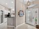 A view of the home's entry foyer leading to the kitchen at 26111 Feathersound Dr, Punta Gorda, FL 33955