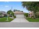 Charming single-story home with a well-manicured lawn and a two-car garage at 26111 Feathersound Dr, Punta Gorda, FL 33955