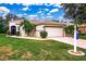 Charming single-story home featuring a tile roof, two-car garage, and well-maintained landscaping at 26111 Feathersound Dr, Punta Gorda, FL 33955