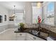 Bright kitchen area featuring granite countertops, a stainless steel sink, and a mosaic backsplash at 26111 Feathersound Dr, Punta Gorda, FL 33955