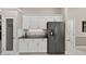 Well-equipped kitchen featuring white cabinets, a stainless steel refrigerator, and granite countertops at 26111 Feathersound Dr, Punta Gorda, FL 33955