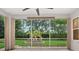 Relaxing screened lanai overlooking a beautifully landscaped backyard with mature trees at 26111 Feathersound Dr, Punta Gorda, FL 33955