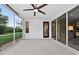 Spacious screened lanai with a ceiling fan, offering serene outdoor living space at 26111 Feathersound Dr, Punta Gorda, FL 33955