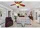 A view of the living room featuring neutral colors and a ceiling fan at 26111 Feathersound Dr, Punta Gorda, FL 33955