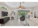 A view of the living room featuring neutral colors, a ceiling fan, and glass doors to the lanai at 26111 Feathersound Dr, Punta Gorda, FL 33955