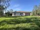 Backyard with grass extending out to the treeline at 27128 Aloha Dr, Punta Gorda, FL 33955