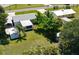 An aerial view of the backyard reveals green grass and screened in porch plus storage shed at 2805 Gussie St, Punta Gorda, FL 33950