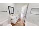 Bright bathroom with stylish vanity, new fixtures, white walls, and bathtub, offering a comfortable and relaxing space at 2805 Gussie St, Punta Gorda, FL 33950