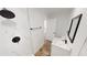 Modern bathroom with a sleek shower, white vanity with black fixtures and a large framed mirror at 2805 Gussie St, Punta Gorda, FL 33950