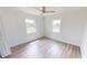Bright bedroom showcasing wood floors, white walls, and two windows, perfect for a minimalist design and natural light at 2805 Gussie St, Punta Gorda, FL 33950