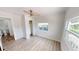Bright bedroom with two windows and a ceiling fan, showcases vinyl floors, and an ensuite bath at 2805 Gussie St, Punta Gorda, FL 33950