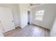 A minimalist bedroom offers a window and closet, complemented by wood-look floors and white walls for a cozy design at 2805 Gussie St, Punta Gorda, FL 33950