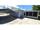 Exterior view showcasing a carport, a screened porch and nicely landscaped areas, providing additional parking at 2805 Gussie St, Punta Gorda, FL 33950