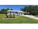 Charming single-story home with a manicured lawn, quaint carport, and inviting front porch at 2805 Gussie St, Punta Gorda, FL 33950