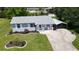 Charming single-story home with a manicured lawn, quaint carport, and inviting front porch at 2805 Gussie St, Punta Gorda, FL 33950