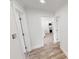 Bright hallway features beautiful floors and leads to a clean and modern kitchen space at 2805 Gussie St, Punta Gorda, FL 33950