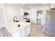 New kitchen with stainless steel appliances, black hardware, and an island featuring a breakfast bar at 2805 Gussie St, Punta Gorda, FL 33950