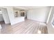 Open concept living room with new floors adjacent to the modern kitchen with island at 2805 Gussie St, Punta Gorda, FL 33950