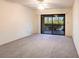 Bright bedroom with a ceiling fan featuring a large glass sliding door leading to an outdoor patio area at 3256 White Ibis Ct # 24A, Punta Gorda, FL 33950