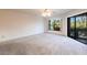 A large bedroom with wall-to-wall carpet, and access to a lanai at 3256 White Ibis Ct # 24A, Punta Gorda, FL 33950