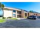 Condo building with dedicated parking, mature landscaping, and second story units with private balconies at 3256 White Ibis Ct # 24A, Punta Gorda, FL 33950