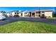 A ground-level view of the building exterior showing assigned parking and landscaping at 3256 White Ibis Ct # 24A, Punta Gorda, FL 33950