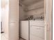 Convenient laundry area featuring a washer and dryer, plus shelving for storage at 3256 White Ibis Ct # 24A, Punta Gorda, FL 33950