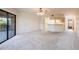 A bright living room with neutral carpet and an opening into the kitchen at 3256 White Ibis Ct # 24A, Punta Gorda, FL 33950