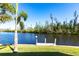 Beautiful canal view featuring a lush tree line and private dock at 3256 White Ibis Ct # 24A, Punta Gorda, FL 33950