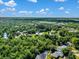 Gorgeous aerial view showing property nestled amongst lush green trees and waterways under a sunny sky at 3616 Allapatchee Dr, Punta Gorda, FL 33950