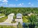 Aerial shot of a home and detached garage with lush greenery surrounding the property at 3616 Allapatchee Dr, Punta Gorda, FL 33950