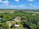 Aerial view showcases houses amongst the trees and waterways with a beautiful view of the city at 3616 Allapatchee Dr, Punta Gorda, FL 33950