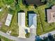 Aerial view of house and detached garage with surrounding waterway and greenery at 3616 Allapatchee Dr, Punta Gorda, FL 33950