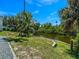 A lush green backyard featuring canal front access and a well-maintained lawn at 3616 Allapatchee Dr, Punta Gorda, FL 33950