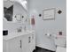 Stylish bathroom with modern vanity, framed mirror, and coastal decorations at 3616 Allapatchee Dr, Punta Gorda, FL 33950