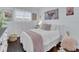 Cozy bedroom featuring a bed with decorative pillows and textured accents with dark wood floors at 3616 Allapatchee Dr, Punta Gorda, FL 33950