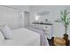 Bright bedroom featuring a bed with decorative pillows and a dresser with dark wood floors at 3616 Allapatchee Dr, Punta Gorda, FL 33950