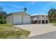 Charming elevated home with a two car garage and a large paved parking area at 3616 Allapatchee Dr, Punta Gorda, FL 33950
