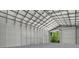 The interior of a large metal building features a tall ceiling and open door at 3616 Allapatchee Dr, Punta Gorda, FL 33950