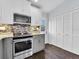 Well-equipped kitchen with stainless steel appliances, mosaic backsplash and gray and white cabinetry at 3616 Allapatchee Dr, Punta Gorda, FL 33950