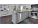 Kitchen with gray countertops, stainless steel appliances and ample cabinet space at 3616 Allapatchee Dr, Punta Gorda, FL 33950