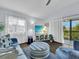 Bright living room featuring comfortable seating, a ceiling fan, and a view of the outdoors at 3616 Allapatchee Dr, Punta Gorda, FL 33950