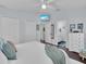 Spacious main bedroom featuring ensuite bath, TV, ceiling fan, and lots of closet space at 3616 Allapatchee Dr, Punta Gorda, FL 33950