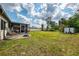 A spacious backyard featuring a fire pit, seating, and mature trees at 4044 S Salford Blvd, North Port, FL 34287