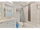 Neat bathroom featuring updated tiling, a shower and bath combo, and an updated sink at 4044 S Salford Blvd, North Port, FL 34287
